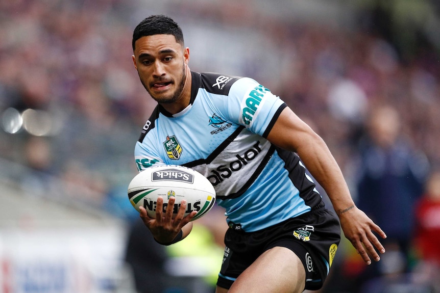 Valentine Holmes carries the ball for the Sharks.