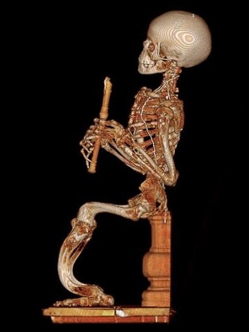 A seated skeleton holding a wooden recorder