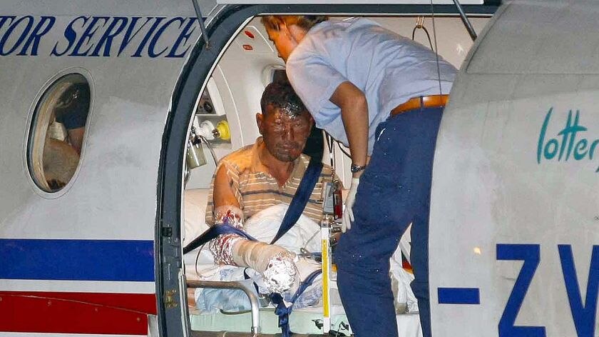 A badly injured asylum seeker is attended to by medical personnel after arriving in Broome