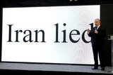 Benjamin Netanyahu stands in front of a big digital display that reads "Iran lied".