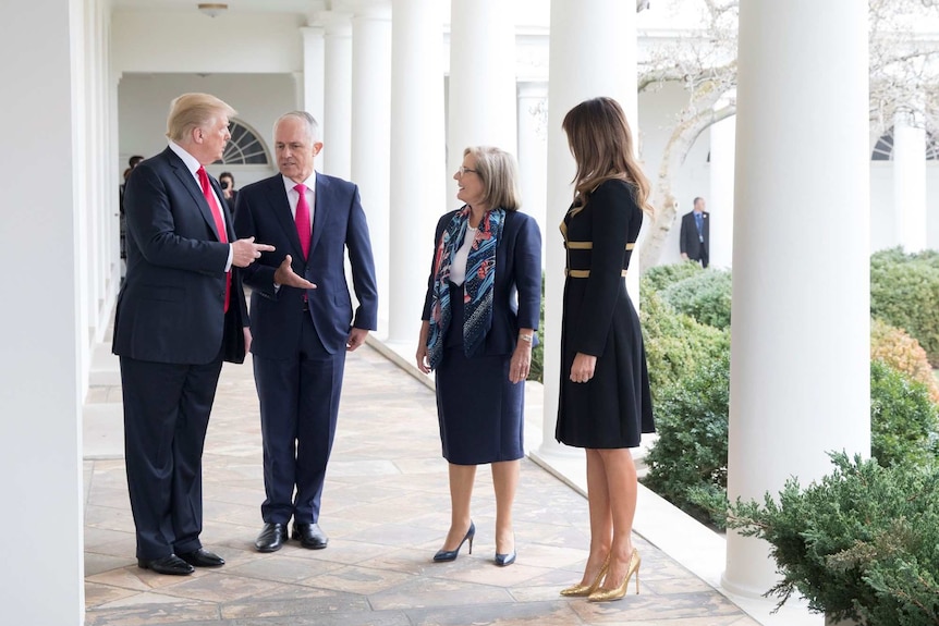 Donald Trump and Malcolm Turnbull chat on an outdoor path at the White House with Lucy Turnbull and Melania Trump