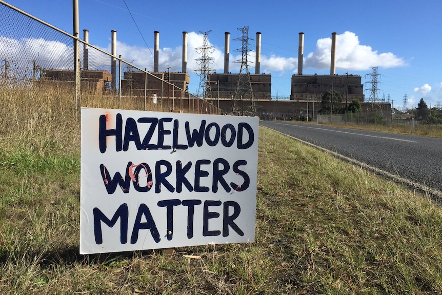 A hand-painted sign which reads 'Hazelwood workers matter' sits in the long grass on the road to the power station.