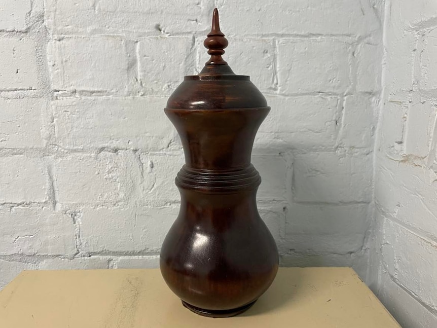 wooden urn on a bench.