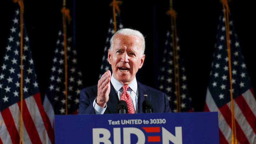 Democratic US presidential candidate and former Vice President Joe Biden speaks from a podium.
