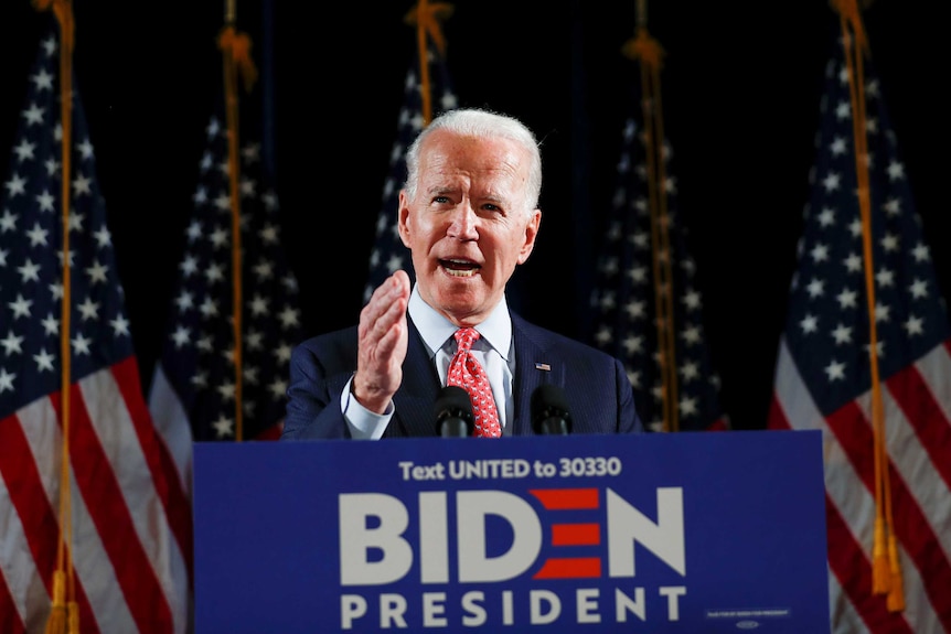 Democratic US presidential candidate and former Vice President Joe Biden speaks from a podium.