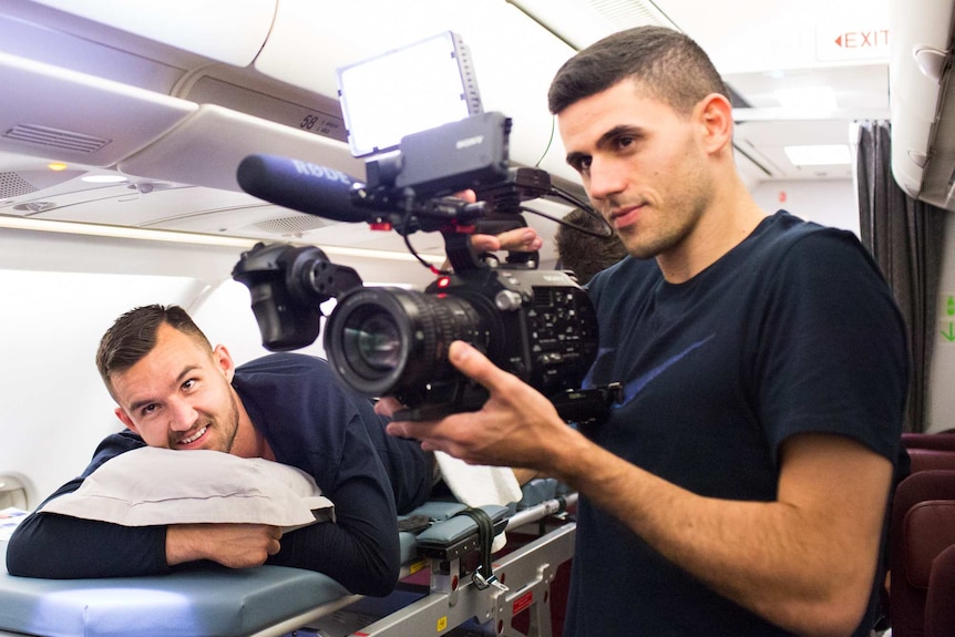 Tom Rogic fools around with a video camera on the Socceroos charter flight