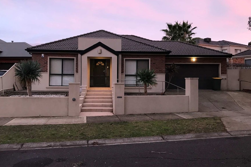 A brick house on a suburban street.