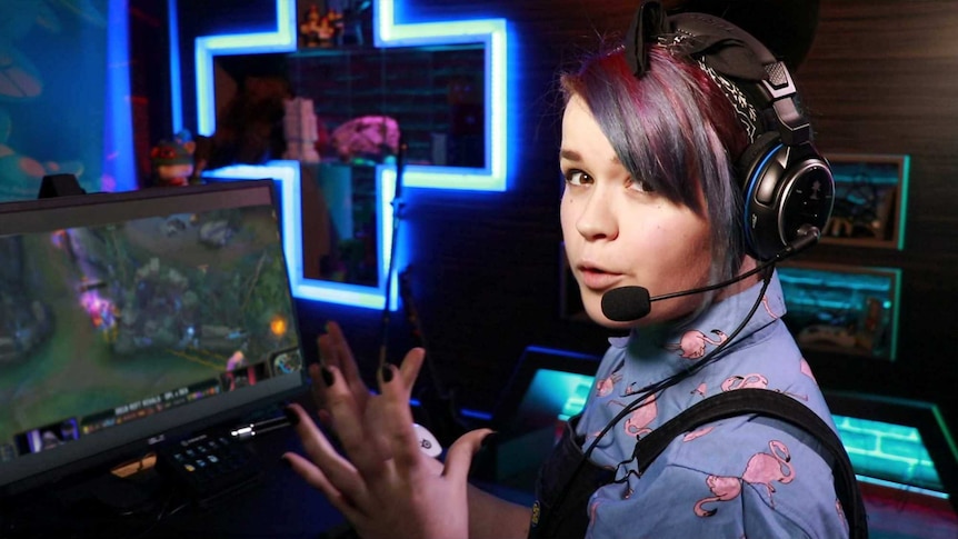 Gem in a gaming headset in front of a League of Legends game.