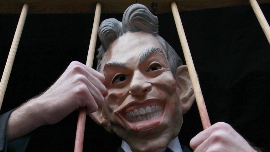 A demonstrator wears a Tony Blair mask outside the Chilcot Inquiry in central London.