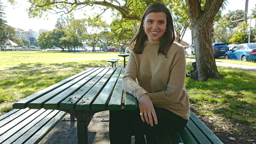 Annabel Munro sitting at a park bench in Double Bay.