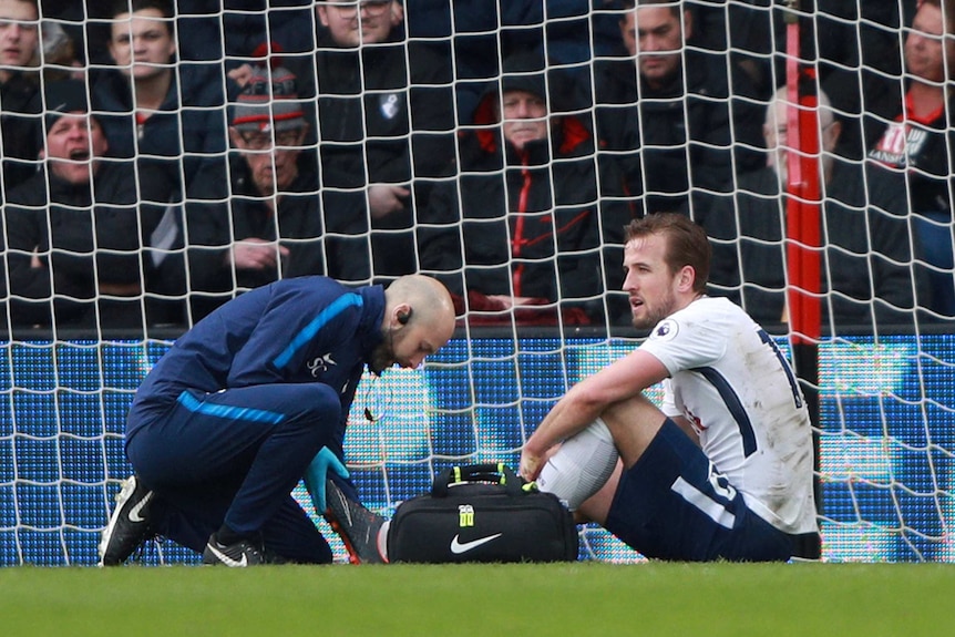 Tottenham's Harry Kane gets medical attention on an injury against Bournemouth on March 11, 2018.