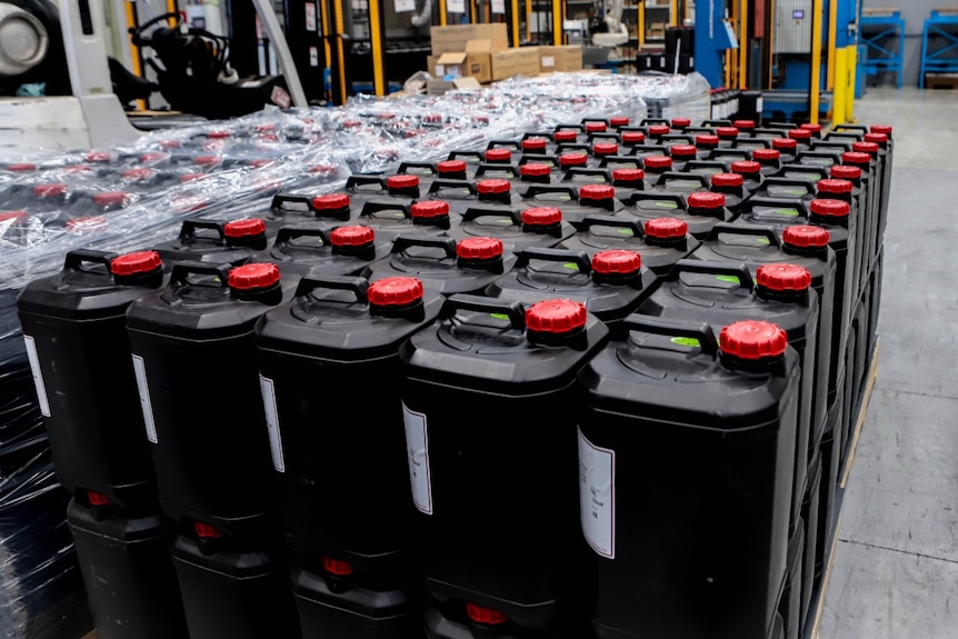 Dozens of big plastic chemical bottles.