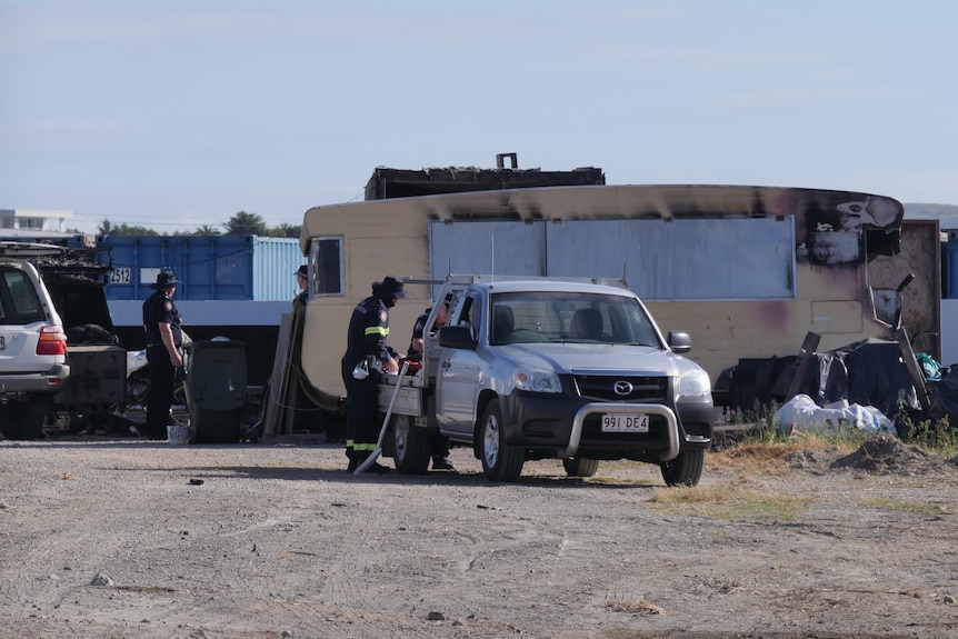 police stand over the back of a ute