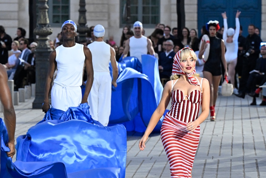 Sabrina Carpenter walks in a street runaway show in Paris in a retro inspired outfit