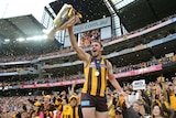 On a high ... Brent Guerra lifts the AFL premiership cup after Hawthorn won the grand final