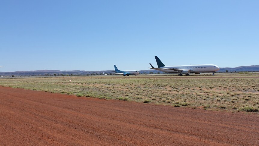 Two planes on flat landscape.