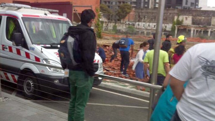 An ambulance arrives at the scene of a wall collapse on Swanston St