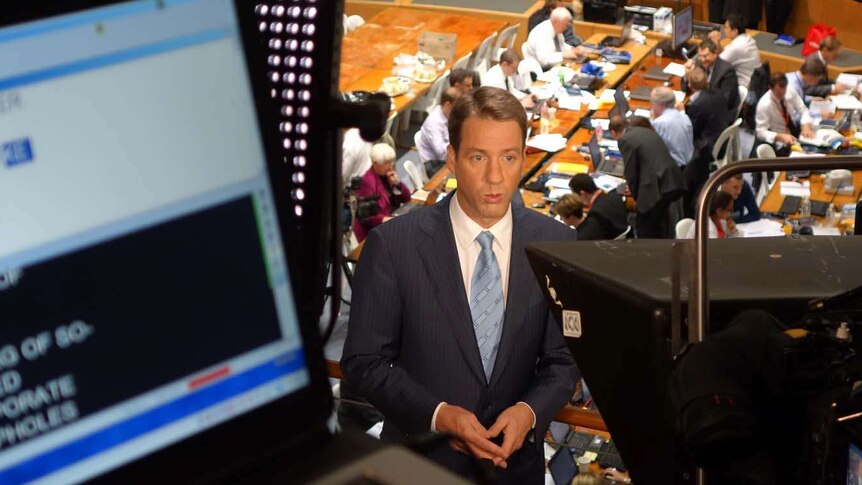 Mark Simkin records a TV news bulletin from within the 2013 Budget lockup