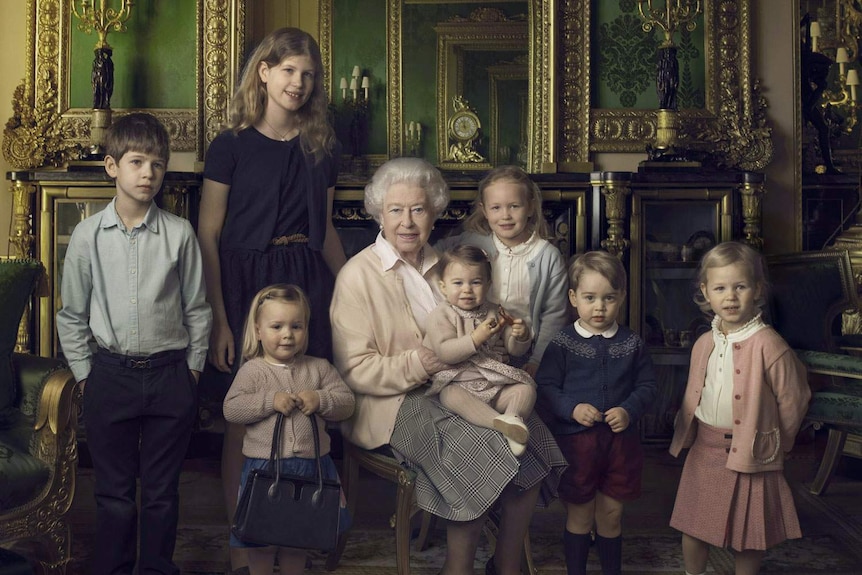 Queen Elizabeth II and various royal children pose for an official portrait in Windsor Castle.
