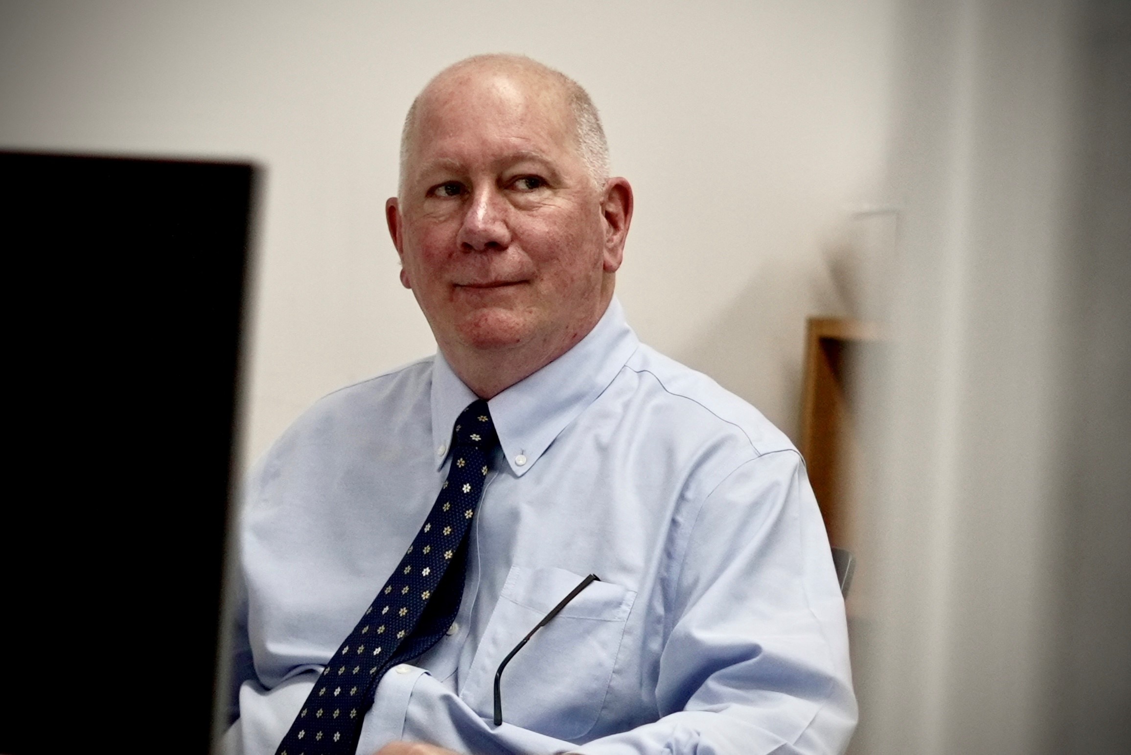 a man looking serious in his office