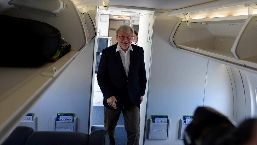 Prime Minister Kevin Rudd boards a media plane in Darwin