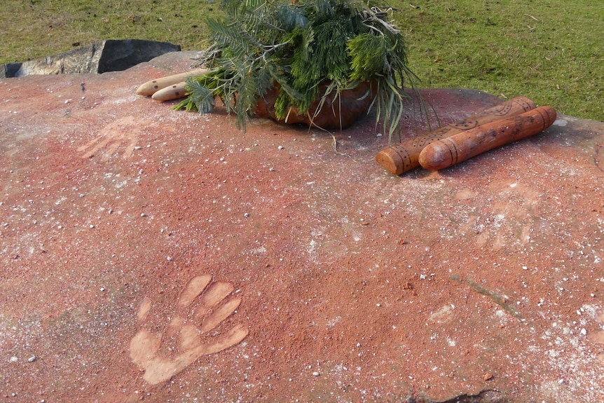 Hand prints in rock with ochre.