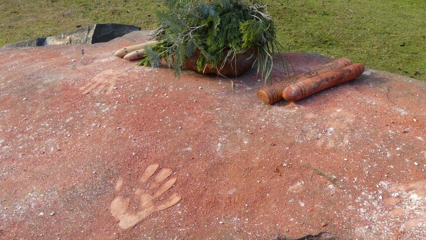 Hand prints in rock with ochre.