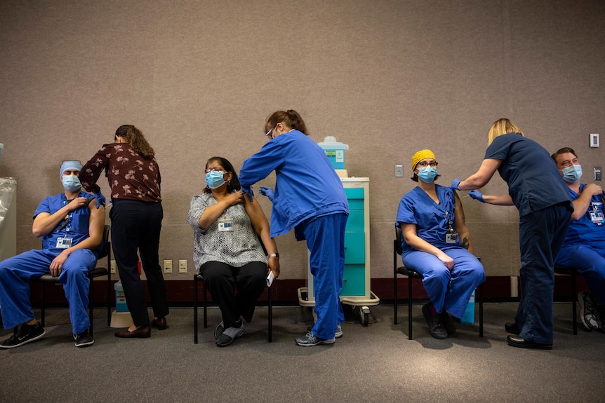 Healthcare workers get the Pfizer-BioNTech vaccine
