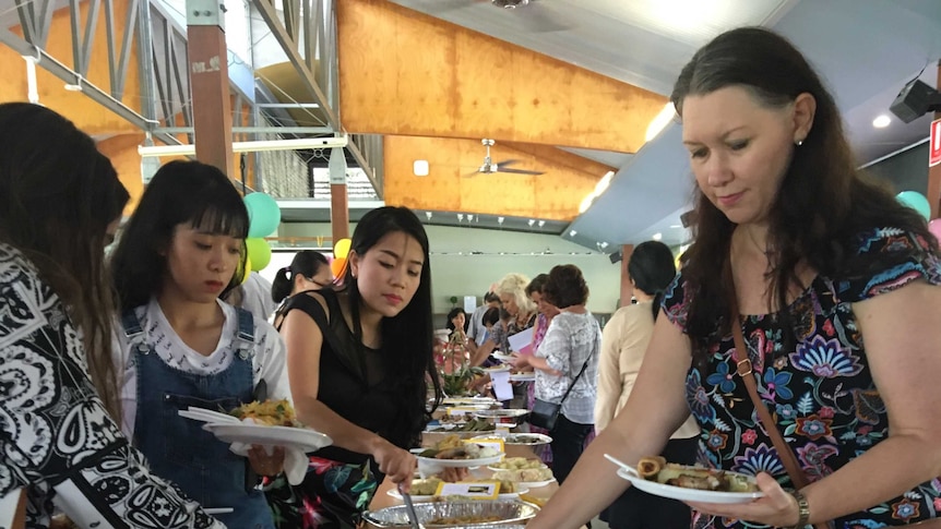 a group of people enjoy lunch at lunar new year