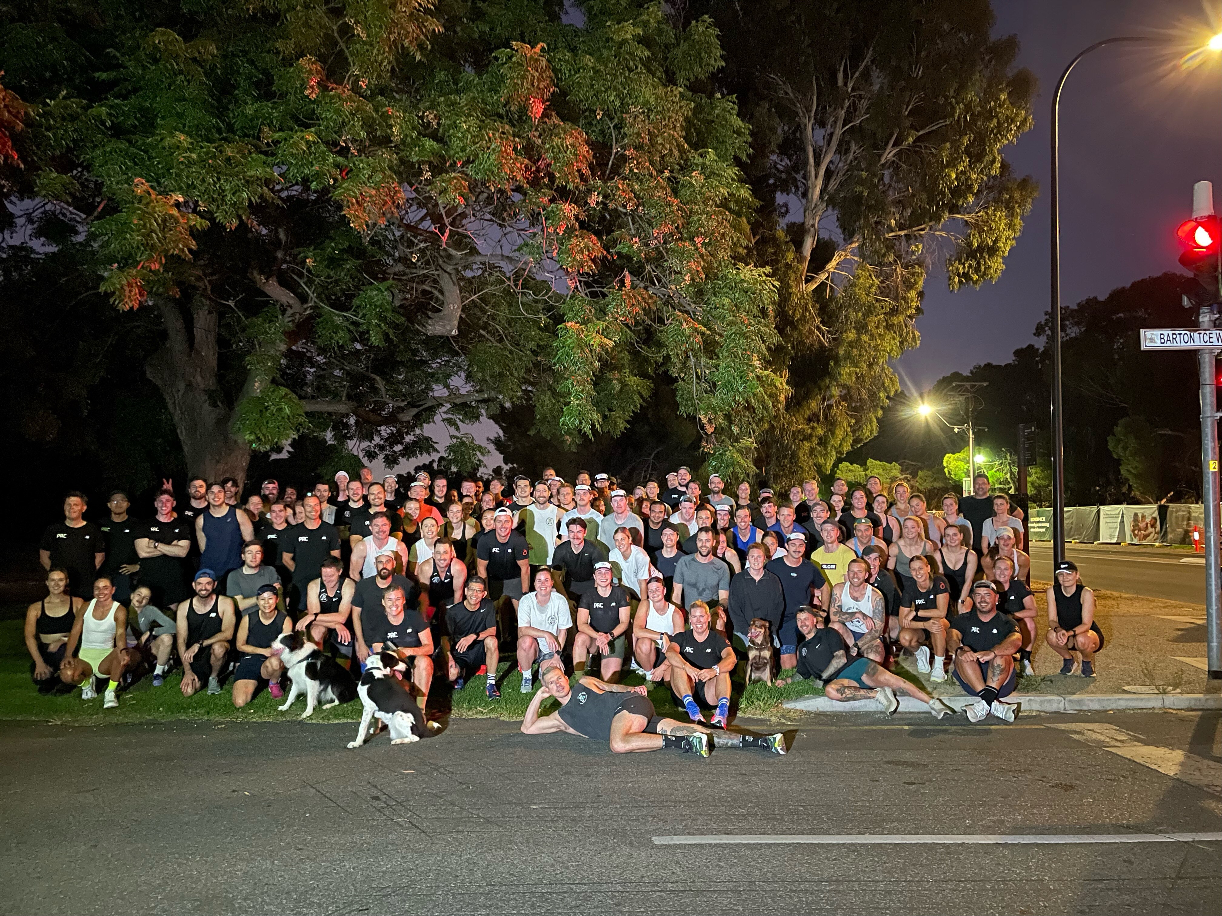 Group of people smile at camera in running attire