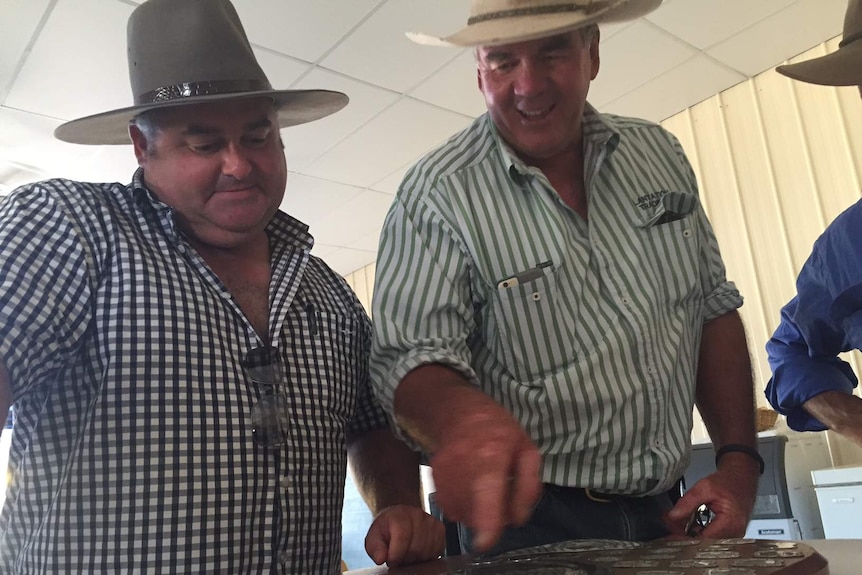 2016 Premer Shield winner Michael Norman and Local Farmer of the Year winner Ed Simson point to names on the Premer Shield