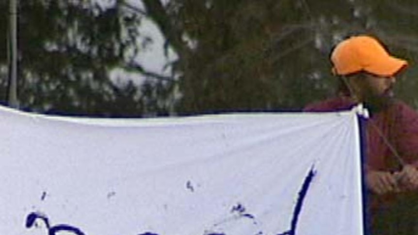 Protesters sit on the roof of Villawood detention centre