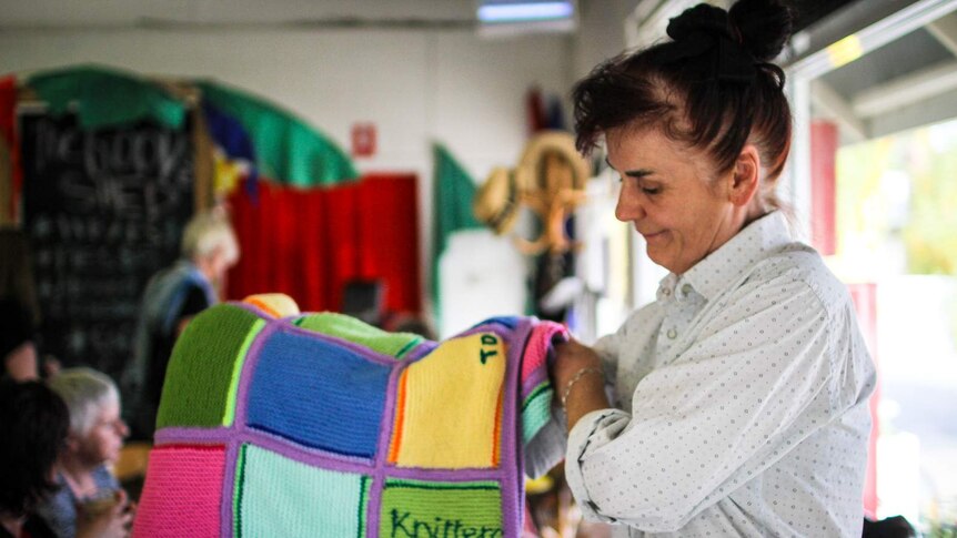 Srebrenka Kunek, who runs The Goods Shed in Taradale, holding one of the knitted woollen blankets.