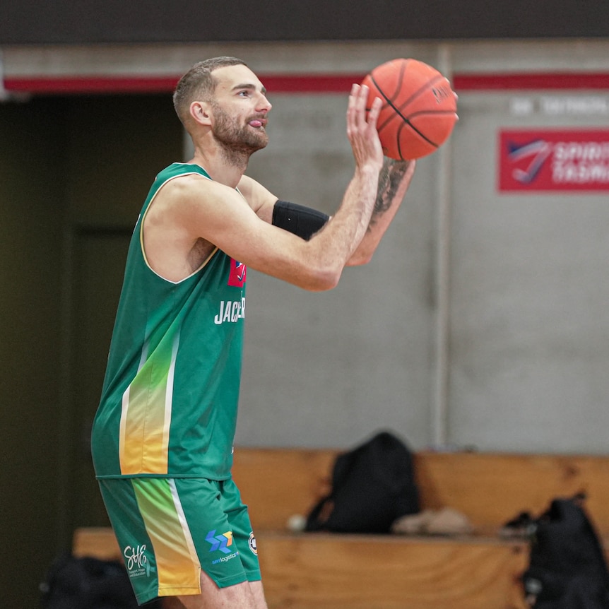A basketballer practising shooting.