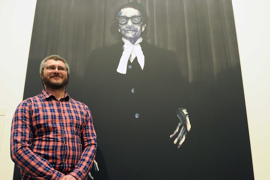 Nigel Milsom with his Archibald-winning painting