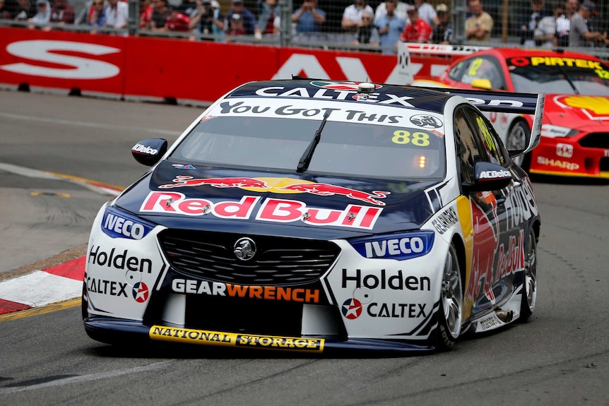 A Supercars driver going around a corner in a Holden Commodore.