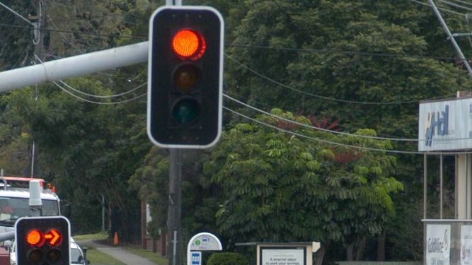 Cars sit at a red light