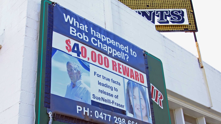 A billboard on the side of a building requesting information on Bob Chappell's disappearance and offering a reward.