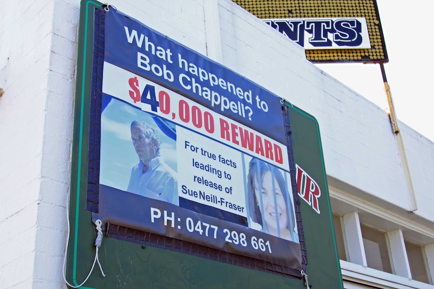 A billboard on the side of a building requesting information on Bob Chappell's disappearance and offering a reward.