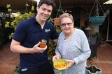 Dave Weir and his grandmother Phyllis Forbes holding a jar of marmalade and some fruit.