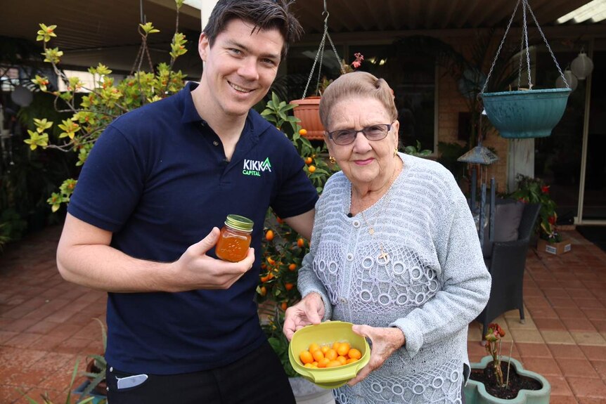 Dave Weir and his grandmother Phyllis Forbes holding a jar of marmalade and some fruit.