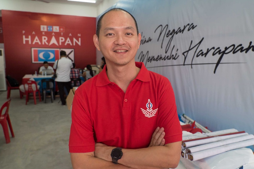 A Malaysian MP crosses his arms in his office