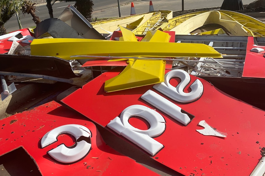 A smashed McDonald's sign lying on the ground