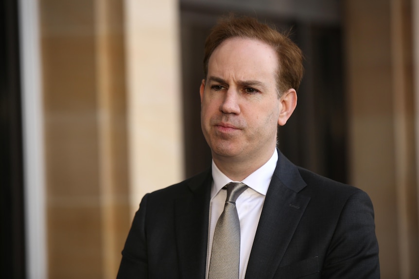 Warren Pearce wears a suit and tie outside WA parliament