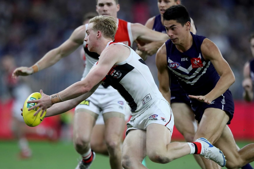 Dockers tagger Bailey Banfield chases St Kilda player Ed Phillips during an AFL game.