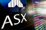 An ASX board with ASX in focus and stock prices out of focus.