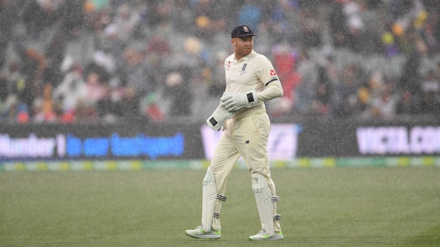 Jonny Bairstow looks around at Adelaide Oval as rain comes down.