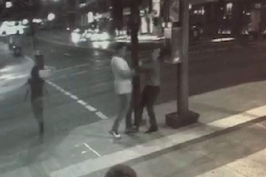 Two men fight in a street in Fortitude Valley.