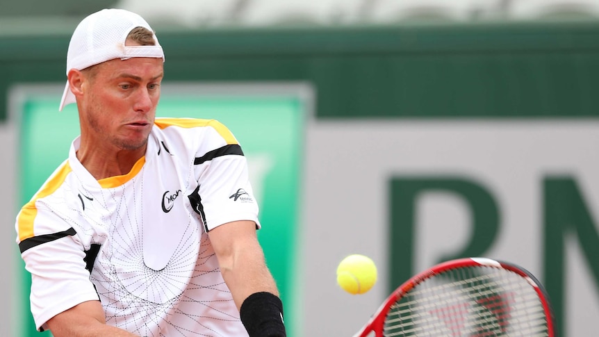 Australia's Lleyton Hewitt plays a backhand against Gilles Simon at the French Open.