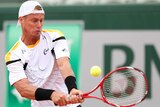 Australia's Lleyton Hewitt plays a backhand against Gilles Simon at the French Open.